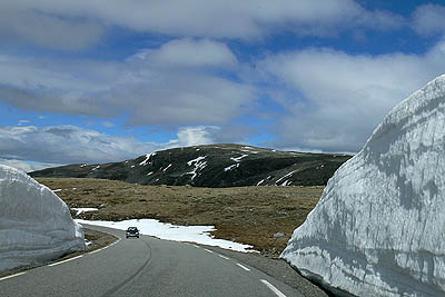 Aurlandsvegen: tie kulkee lumikasojen välistä